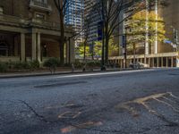 two benches on the side of a street in front of some tall buildings and buildings