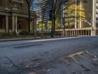 two benches on the side of a street in front of some tall buildings and buildings