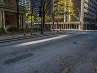 two benches on the side of a street in front of some tall buildings and buildings