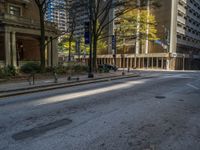 two benches on the side of a street in front of some tall buildings and buildings