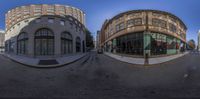 360 - view of the buildings in a row with a man riding a motorcycle in front