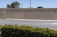 the stop sign stands for attention on a road corner in front of a brick building