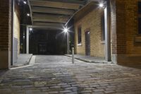 there is a view of a street from the building doorways at night that are busy with buildings