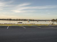 there is a view of a body of water with cars on it from a parking lot