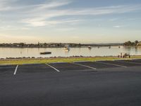 there is a view of a body of water with cars on it from a parking lot