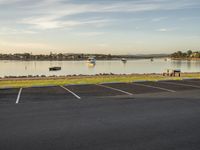 there is a view of a body of water with cars on it from a parking lot