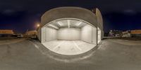 this is an overhead shot of a man standing inside a white garage on his skateboard