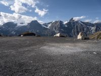 two rock - strewn mountains are seen with snow on them and rocks lying across from each other