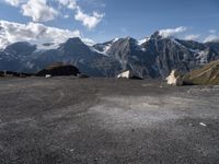 two rock - strewn mountains are seen with snow on them and rocks lying across from each other