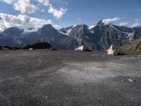 two rock - strewn mountains are seen with snow on them and rocks lying across from each other