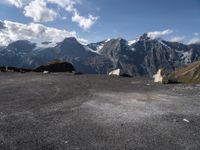 two rock - strewn mountains are seen with snow on them and rocks lying across from each other