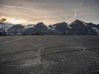 a view of a parking lot with the mountain on the other side and a plane in the middle