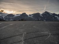 a view of a parking lot with the mountain on the other side and a plane in the middle