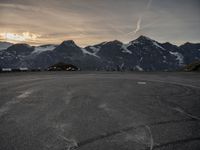 a view of a parking lot with the mountain on the other side and a plane in the middle