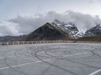 a picture of a winding road and some mountains in the back ground of the image