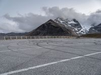 a picture of a winding road and some mountains in the back ground of the image