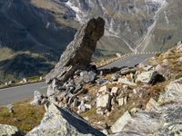 the large rock is leaning to allow you to move to the right side of the road