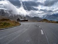 the road winds in for storm approaching the clouds and fog on top of the mountain