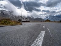 the road winds in for storm approaching the clouds and fog on top of the mountain