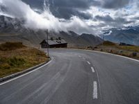 the road winds in for storm approaching the clouds and fog on top of the mountain