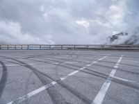 a train traveling over the top of an overpass next to a cloudy sky above