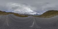 a 360 - view image of the road with the mountains in the background is shown