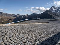 a curved street with mountains behind it in the background to provide a perspective for the curve