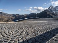 a curved street with mountains behind it in the background to provide a perspective for the curve