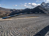 a curved street with mountains behind it in the background to provide a perspective for the curve