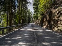 empty road surrounded by trees near the mountains, with no one on it, for the first time