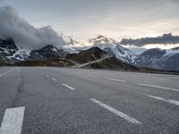 a highway near a mountain range with a small bridge in it's middle lane