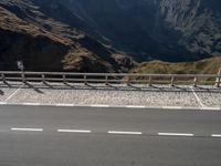 an empty road with no people in sight on it and a sign for the right way