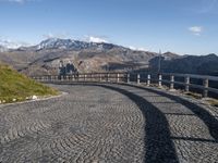 stone road in mountains with hills in the background on a sunny day in italy at the edge