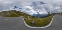 a 360 - view is shown from a car's perspective mirror at the intersection of a mountain and a street