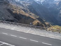 mountains are dotted in a line near a highway with cars on it and people looking out over the valley