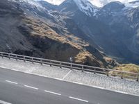 mountains are dotted in a line near a highway with cars on it and people looking out over the valley