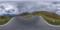 a view of the road from an angle on a cloudy day with clouds in the sky