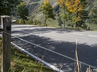 a man is riding his bike down the road towards a scenic view of mountains and trees