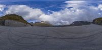 the view of the mountains through a fish eye lens lens with mountains in the background