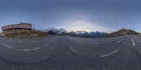 a photo of a view of a street with some mountains in the background in this panorama