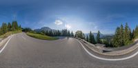 a car driving on the road in the sun and some mountains in the distance in a fish eye lens