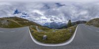 a 360 - view is shown from a car's perspective mirror at the intersection of a mountain and a street