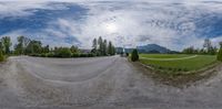 an upside down panoramic image shows the road and surrounding a mountain range, as well as an oval lens