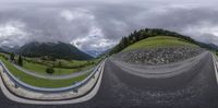 a 360 - view panorama on a road in the middle of the mountains with some trees and hills on each side