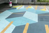 a parking garage has an unusual painted mural on it's surface, outside of a building