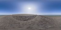 a 360 - view of a lighthouse in the middle of a sandy area with some vegetation