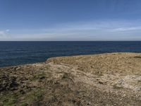 there is a blue sky that can be seen in the distance above the water and land