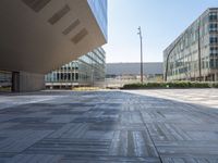 a view from inside a building of two different sized buildings, one in front of the ground and one in back