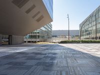 a view from inside a building of two different sized buildings, one in front of the ground and one in back