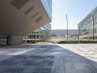 a view from inside a building of two different sized buildings, one in front of the ground and one in back